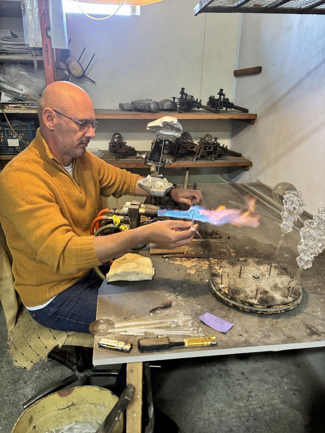 Glass heated over the flame and blown into the mold