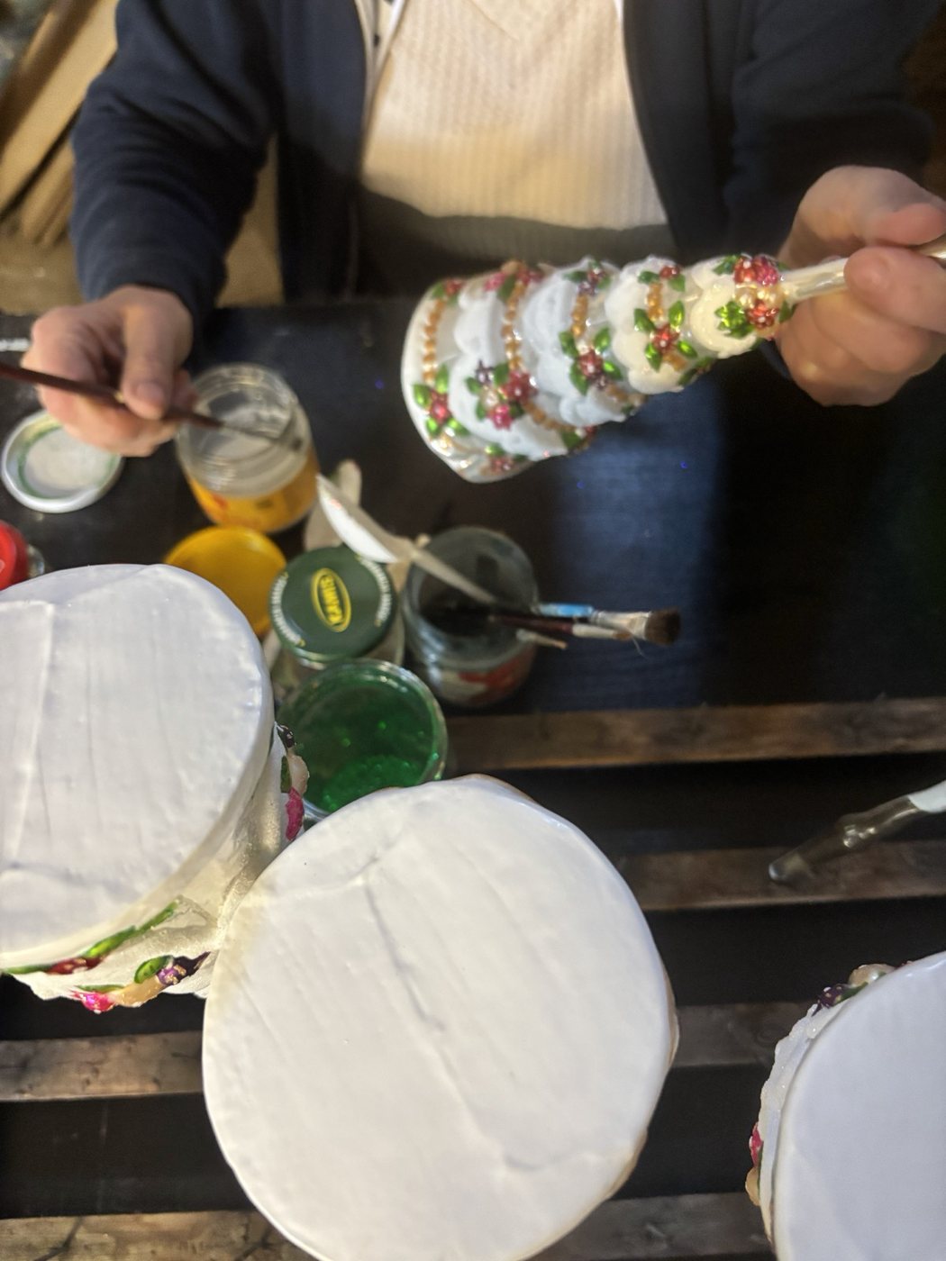 Ornament being painted at the workbench