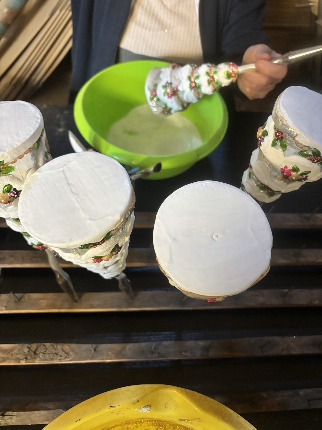 Painter adding glitter to an ornament